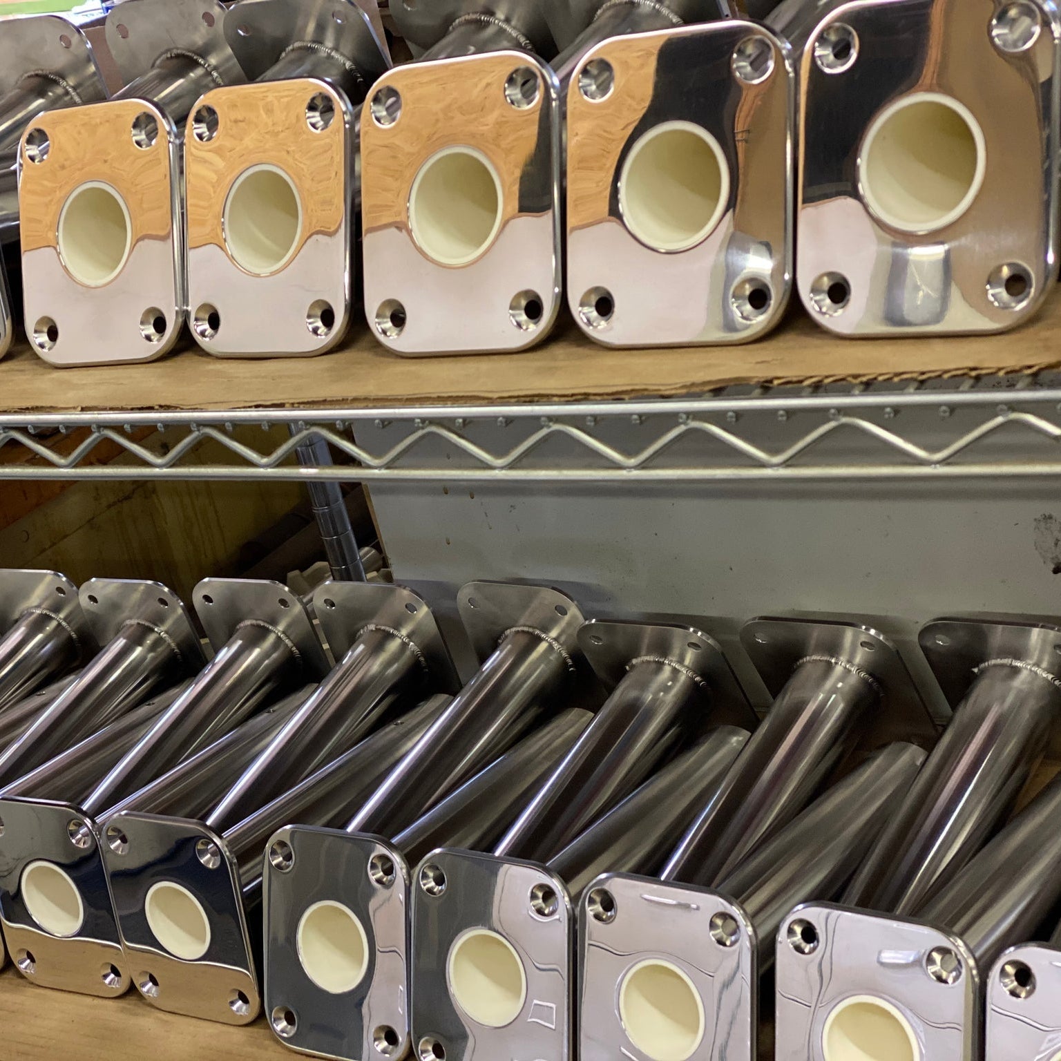 Multiple LT Marine heavy duty swivel rod holders made of stainless steel, displayed on shelves.