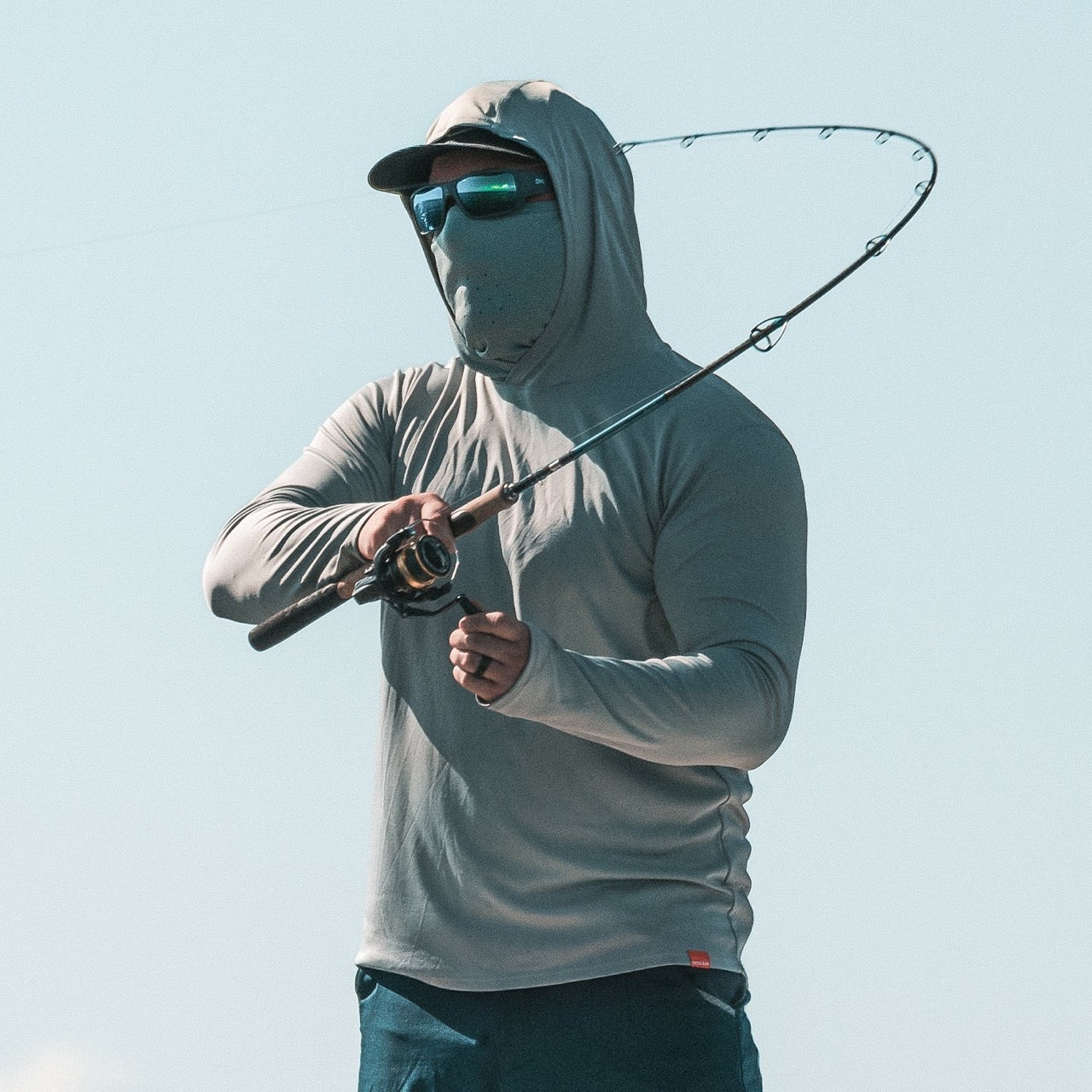 grundens-tough-sun-masked-performance-fishing-hoodie-iceberg-lifestyle-3